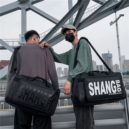 Two people carrying black 'SHANG' bags with a cityscape in the background
