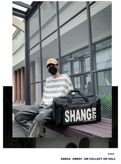 A person sitting on a bench in front of a metal mesh wall wears a striped shirt and gray pants, with a large black duffel bag featuring bold white 'SHANG BAG' text placed on the bench beside them.