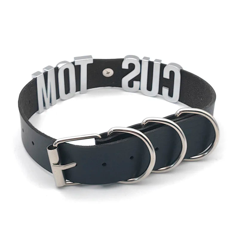 Black dog collar with metal rings and 'GUS' branding on a white background