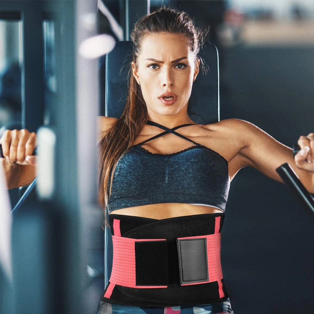 Woman exercising in a gym wearing a pink and black waist trainer.