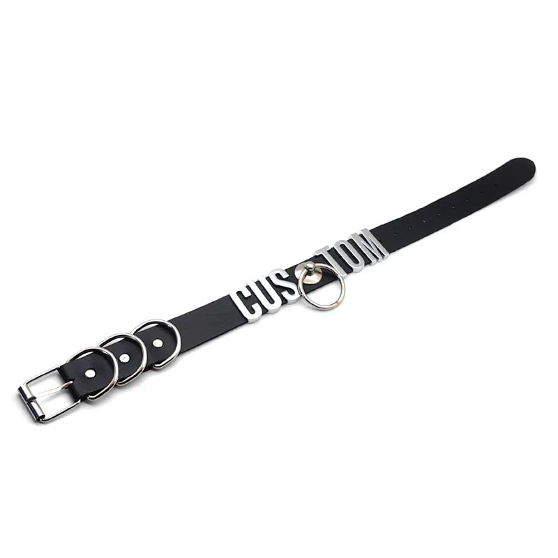 Black leather dog collar with silver hardware on a white background