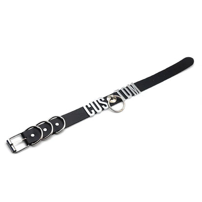 Black leather dog collar with silver hardware on a white background