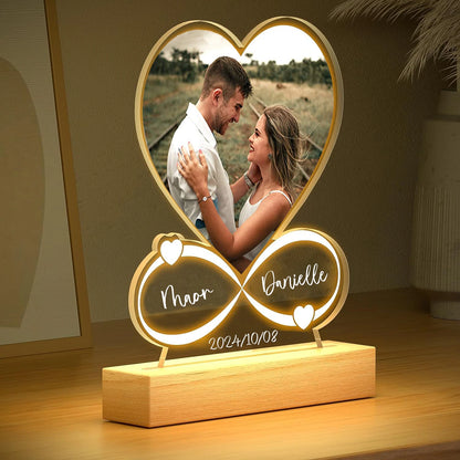 Personalized photo lamp with a heart design, showing a couple and engraved names and date.