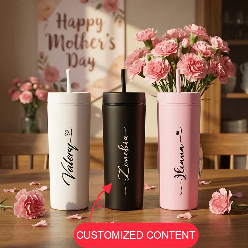 Three personalized tumblers with names 'Valerie', 'Lenevia', and 'Nelena' on a table with pink flowers.
