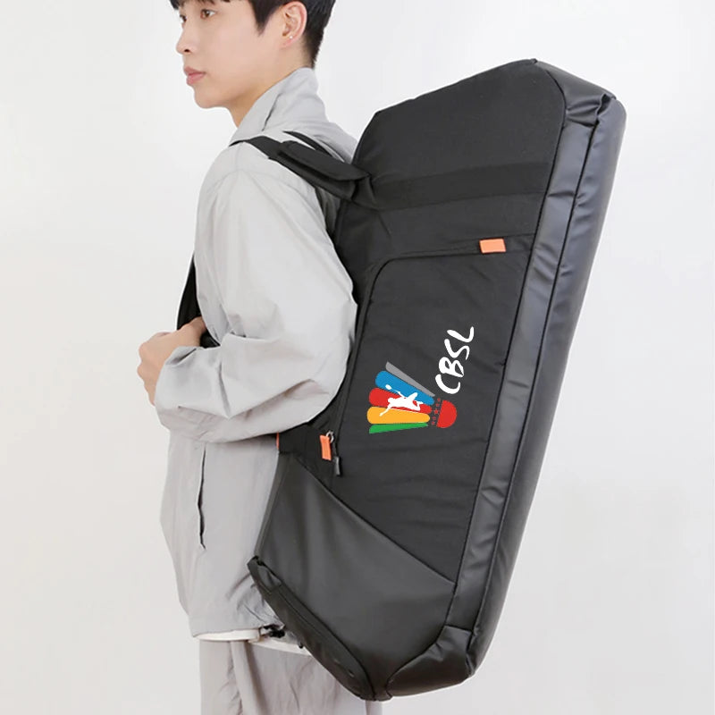 A man wearing a light gray jacket is shown from the side, carrying a large black sports equipment bag on his back. The bag has a colorful logo with the text 'CBSL' on the front pocket, set against a plain white background.