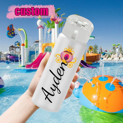 White water bottle with 'Ayden' printed on it held in front of a water park.