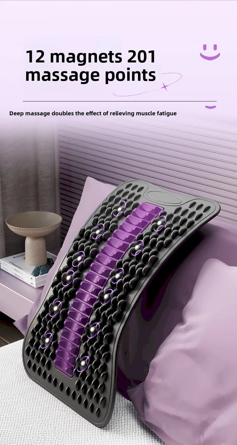 An arc-shaped massage cushion with a black textured surface and purple massage roller bars, shown resting on a bed with pillows. The image includes promotional text at the top stating '12 magnets 201 massage points'.
