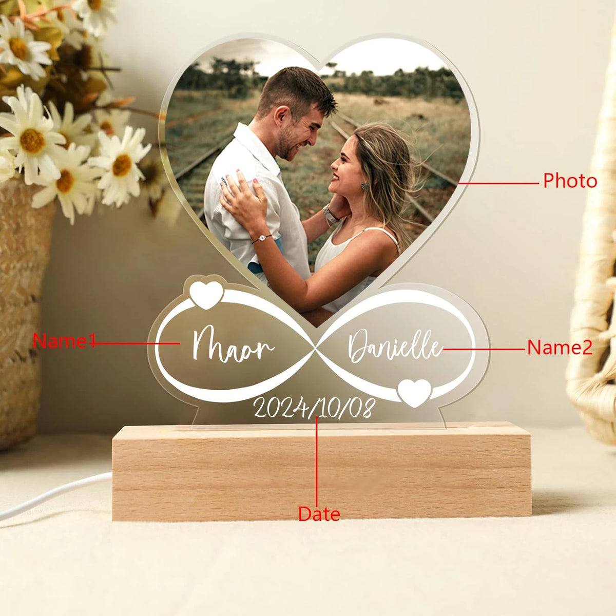 Personalized photo display with names and date on a wooden base, featuring a heart-shaped cutout of a couple.